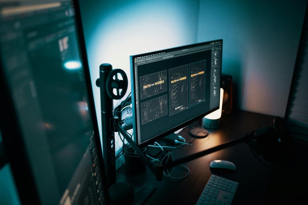 pexels-photo-1714202-1714202 A stylish modern workspace with dual monitors displaying design software in a dimly lit room.